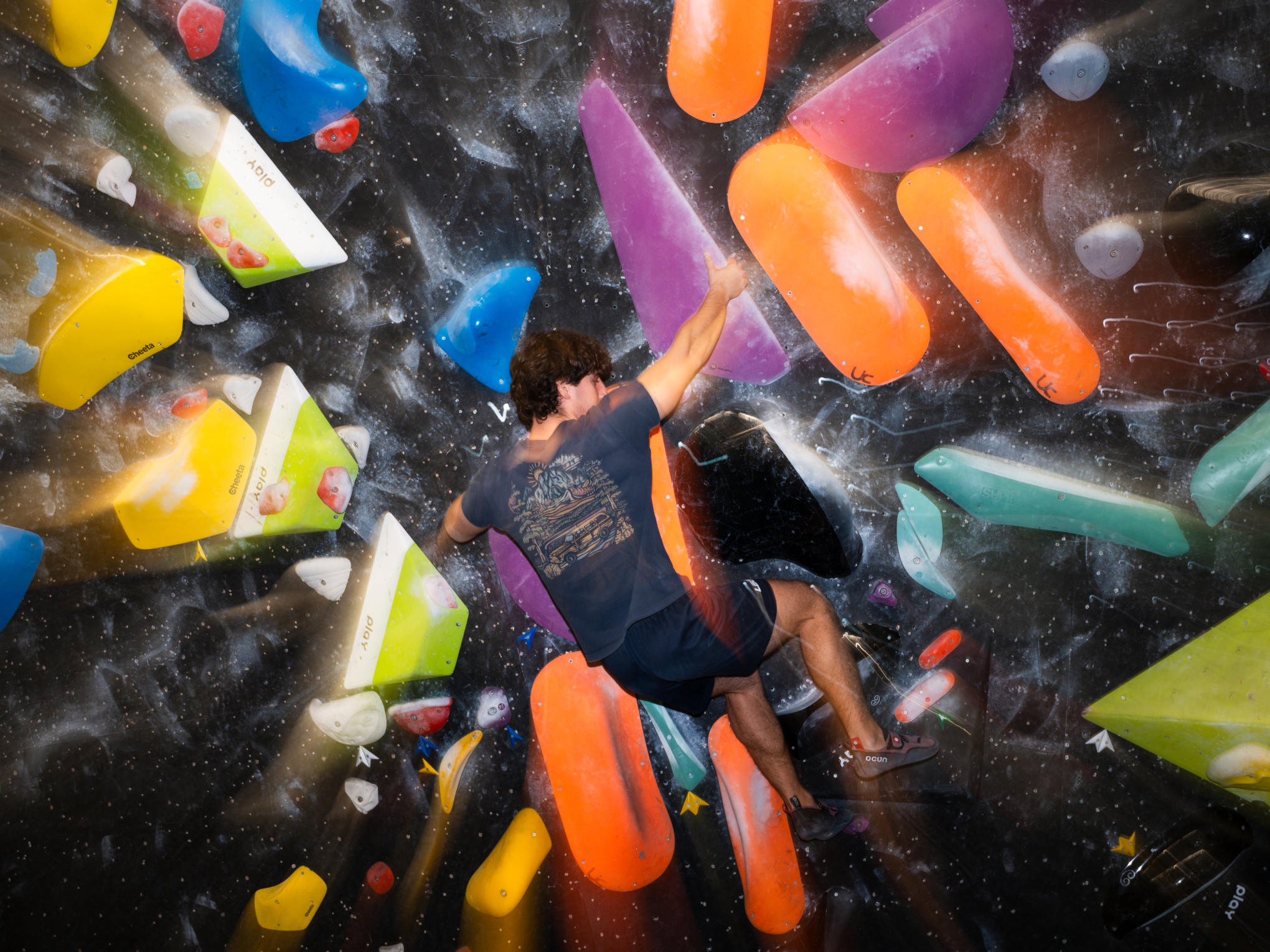 Ragazzo arrampica un Boulder indoor a mialano